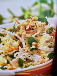 Vietnamese chicken salad on a plate with herbs and mint