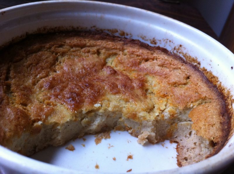 Spoonbread in its souffle dish, scooped out by hungry diners, with about half remaining in the dish