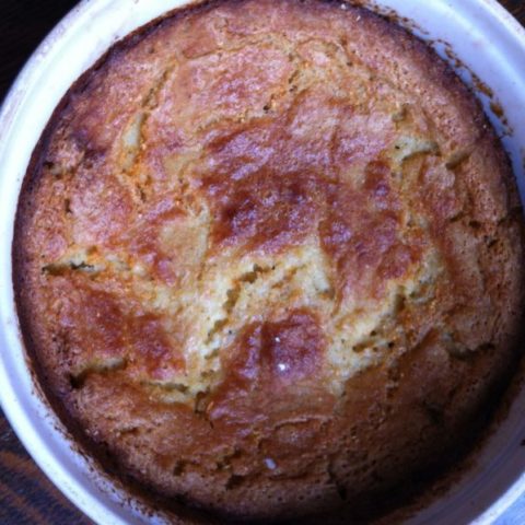 The golden, crusty surface of a warm casserole of spoonbread, a souffle-like version of cornbread enjoyed on Southern tables.
