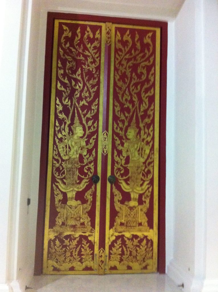 A gorgeous Thai door adorned with traditional Thai painting.