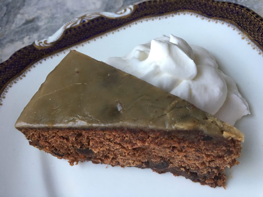 Sticky Toffee Pudding slice with chipped cream showing caramel glaze on top