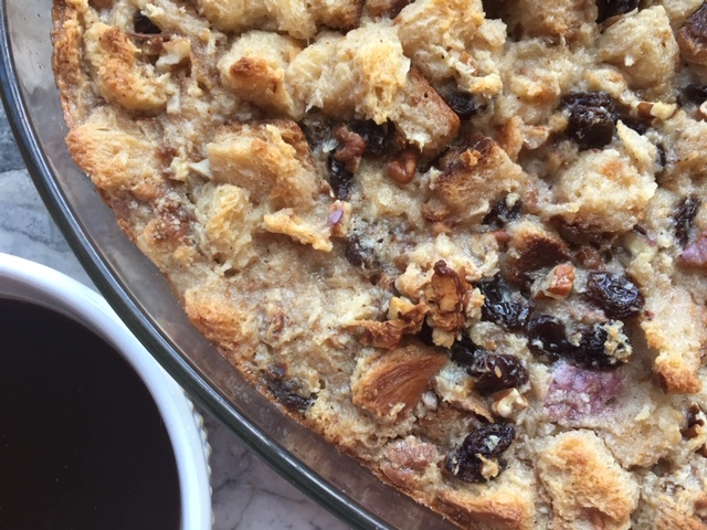 This close-up of the edge of my oval bread pudding and the edge of the bourbon sauce bowl reveals that the bread in this case was King Cake: the bread cube with purple icing peeking out shows the magic!