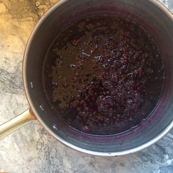 The after picture. Looking down into the copper pot to see blackberries cooked with sugar water and salt to make a sauce. Mashed up and yummy. On a marble slab. 